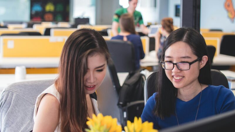 Young professionals creative designers engaged in discussion in office